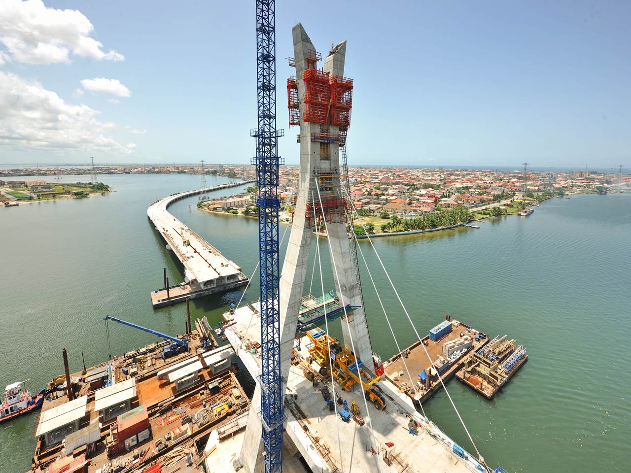 Aerial view of pylon & main bridge under construction with cables in place (julius-berger-int.com)