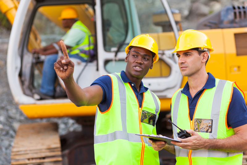 Construction workers discussing on construction site (Hongqi Zhang | Dreamstime)