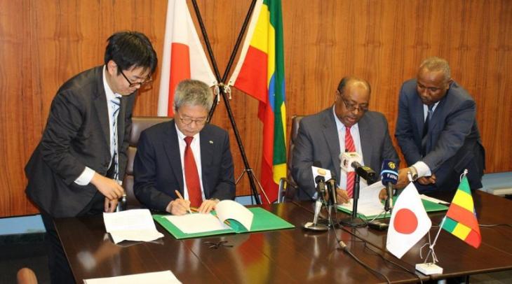 Ethiopia State Minister for Finance, Admasu Nebebe, and the Ambassador of Japan to Ethiopia, Matsunaga Daisuke, signing an agreement