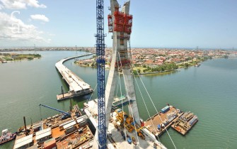 Aerial view of pylon & main bridge under construction with cables in place (julius-berger-int.com)
